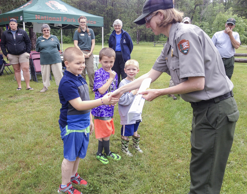 Junior Rangers receiving their certificates during the Active Duty Service Program at Earl Landing on the Namekagon River